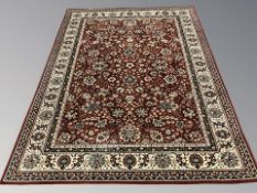 A machine made rug of Persian design,