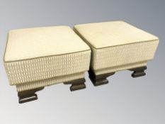 A pair of square footstools in gold fabric, width 54 cm.