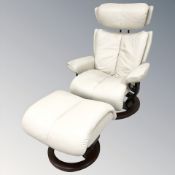 A Norwegian Ekornes stressless cream leather upholstered swivel armchair and matching footstool.