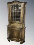 A 20th century oak and leaded glass corner cabinet, height 182 cm.