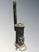 A cast iron stove, Gobin Unit made in France, with chimney flue.