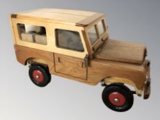 A hand built wooden model of a Land Rover, length 51 cm.