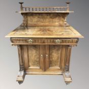 A 19th century Continental walnut writing table fitted a cupboard,