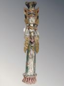 A South-East Asian polychrome painted carved wooden statue, length 100 cm.