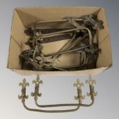 A collection of antique brass pull handles.