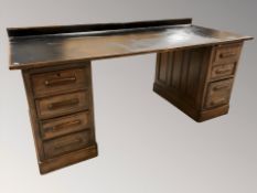 A 1930s oak twin pedestal desk, 186 cm W x 81 cm D x 84 cm H.