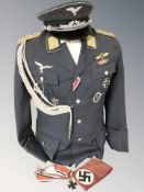 A reproduction German Luftwaffe tunic, cap, arm band, etc.