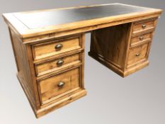 A Barker and Stonehouse reproduction stained pine twin pedestal desk, 194 cm x 80 cm x 83 cm.