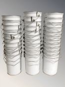 Approximately thirty two enameled metal buckets, each 24 cm high.