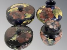 Four pieces of Moorcroft pottery, largest 11 cm high.