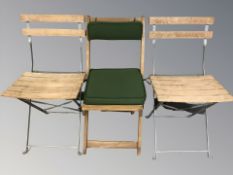A pair of metal framed folding garden chairs and a further chair.