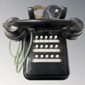 A Bakelite and lacquered metal telephone with bell.