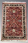 A woolen rug of Persian design, 170 cm x 94 cm.