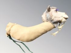 A stuffed fabric camel head and neck.