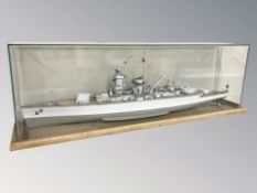 A scale model German pocket battleship on wooden plinth, with glass cover,