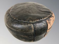 A vintage leather pouffe,