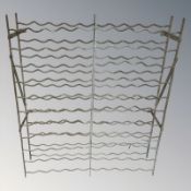 A galvanised metal bottle rack, width 96 cm.