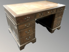 A reproduction nine drawer writing desk,