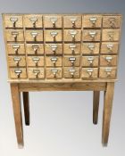 An early 20th century Libraco London oak thirty drawer index chest on stand,