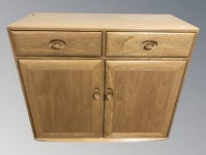 An Ercol light elm sideboard fitted cupboards and drawers, 105 cm W x 44 cm D x 93 cm H.