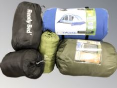 A group of camping equipment including a six person tent, sleeping bag, etc.