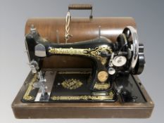 A Singer hand sewing machine, in box.