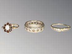 A 9ct gold cluster ring, a 9ct gold and silver eternity ring and another channel-set ring, unmarked.