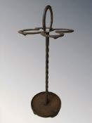 A wrought metal horseshoe stick stand, height 76 cm.