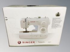 A Singer Talent 3321 sewing machine in box.