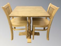 A modern square dining table, width 70 cm, and a pair of chairs.