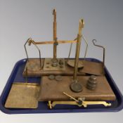Two sets of balance scales and various weights.