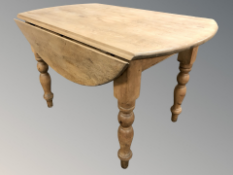A Victorian pine drop leaf dining table,