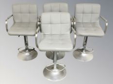A set of four contemporary chrome and grey stitched leather rise and fall bar swivel armchairs,
