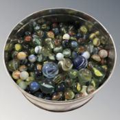 A tin of vintage glass marbles