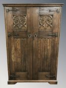 A 20th century oak linen fold double door wardrobe,