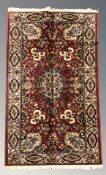 A machine made rug of Persian design, 187 cm x 93 cm.