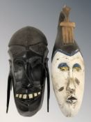 A Maasai carved wooden mask and a further African carved and painted Ivory Coast mask.