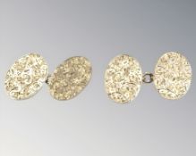 A pair of 9ct gold cuff links with engraved foliate decoration CONDITION REPORT: 8.