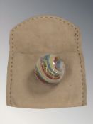 A large banded latticino glass marble, diameter 3 cm.