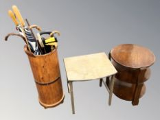 A stick pot containing various walking sticks and umbrellas,