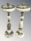 A pair of polished onyx and brass mounted smoker's stands, height 61 cm.