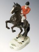 A Beswick huntsman on brown gloss rearing horse numbered 868,
