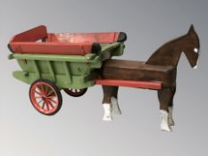 A painted wooden horse and cart model.