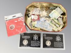 A tin containing assorted coins, foreign bank notes, crowns, etc.