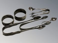 A pair of Georgian Newcastle silver sugar tongs, further smaller pair, plated pair of tongs,