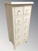 A contemporary painted seven drawer chest,