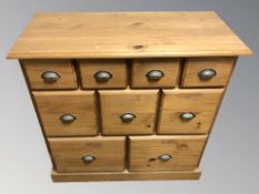 A modern pine nine drawer chest, 89 cm W x 40 cm D x 89 cm H.