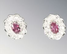 A pair of 9ct gold ruby and diamond cluster earrings, with post fittings,