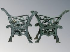 Two pairs of painted cast iron bench ends.