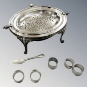 An EPNS revolving-lid entrée dish, width 36cm, together with a pair of silver napkin rings,
